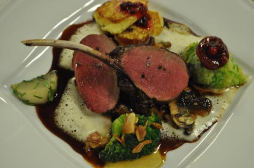 a white plate of food with meat and vegetables at Hotel & Restaurant Schaumburger Ritter, Rinteln in Rinteln