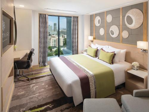 Postel nebo postele na pokoji v ubytování Solitaire Bangkok Sukhumvit 11