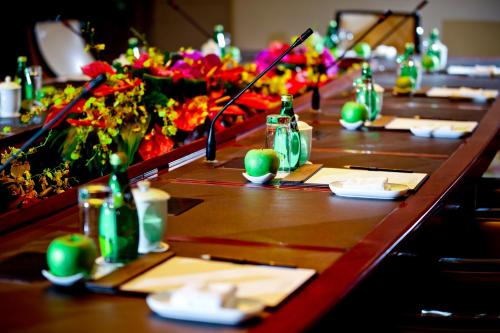 a long table with flowers and bottles on it at Royal International Hotel Shanghai - Pudong International Airport in Shanghai