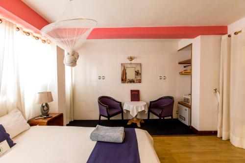 Кровать или кровати в номере Hotel de L'Avenue - Tana City Centre