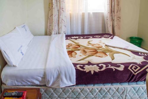Ένα ή περισσότερα κρεβάτια σε δωμάτιο στο Hotel Nok Continental