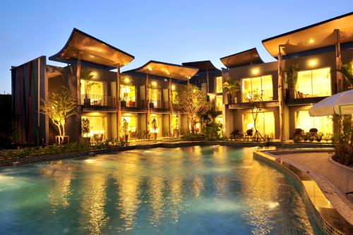 an exterior view of a resort with a swimming pool at Paeva Luxury Serviced Residence SHA in Bang Bo