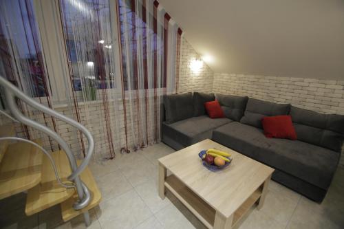a living room with a couch and a coffee table at Апартаменти Маяк in Odesa