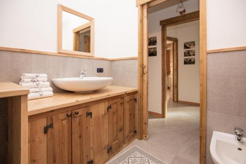 a bathroom with a sink and a mirror at Casa Melide 2 in Bormio
