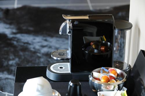 a bowl of candy is next to a toaster at Jugendstil-Hof in Langenlonsheim