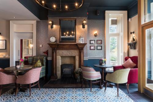 a living room with a fireplace and tables and chairs at The Florentine in Sheffield