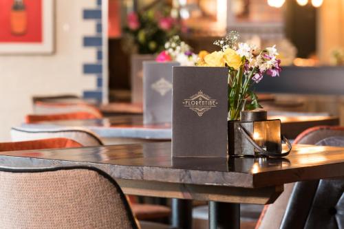 a table with a vase of flowers on it at The Florentine in Sheffield