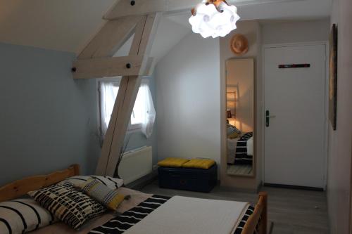 a bedroom with a bed and a large mirror at L'Etape in Belley