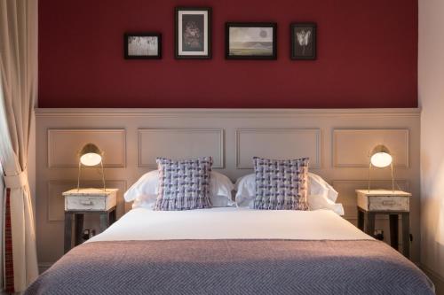 a bedroom with a bed with two lamps on two tables at The Florentine in Sheffield