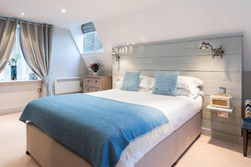 a bedroom with a large bed with a blue blanket at The Florentine in Sheffield