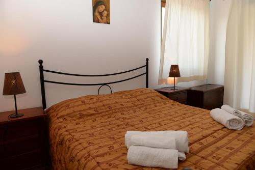 a bedroom with a bed with two towels on it at Case Vacanze La Cernia Bruna in Ustica