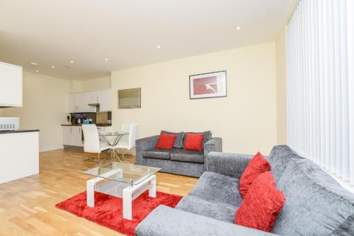 a living room with a couch and a table at PSF Panorama Apartments in Ashford