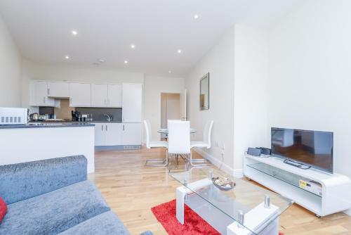 a living room with a couch and a tv at PSF Panorama Apartments in Ashford