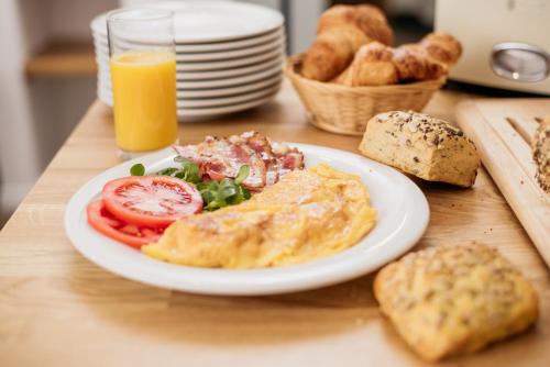 a plate of breakfast food on a table with bread at Sundial Boutique Hotel in Zagreb