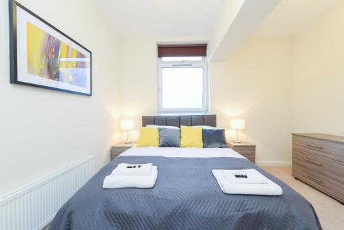 a bedroom with a bed with two towels on it at PSF Panorama Apartments in Ashford