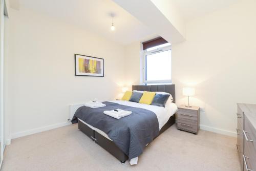 a bedroom with a king sized bed and a window at PSF Panorama Apartments in Ashford