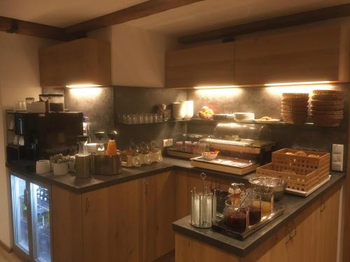 a kitchen with a counter with food on it at Mammhofer Suite & Breakfast in Oberammergau