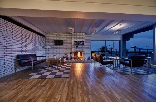 a living room with a fireplace and a brick wall at Hotel Marina in Vedbæk