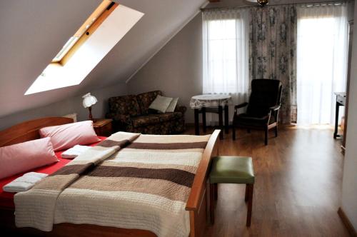 a bedroom with a bed and a living room at Klimbergowice in Sztum
