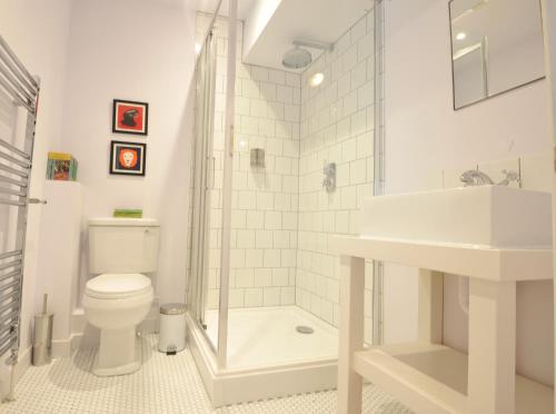 a bathroom with a shower and a toilet and a sink at The Narrowboat in Reading