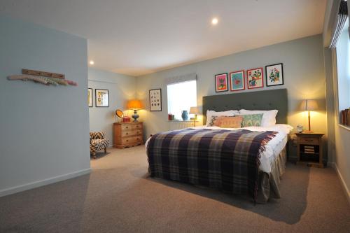 a bedroom with a bed with a plaid blanket at The Narrowboat in Reading