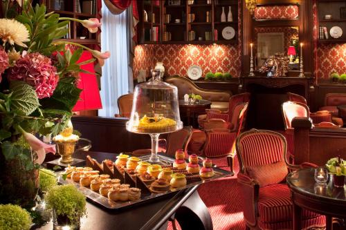a tray of pastries on a table in a room at Auberge du Jeu de Paume in Chantilly