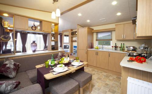 a kitchen and living room with a table and a counter at tattershall lakes in Tattershall