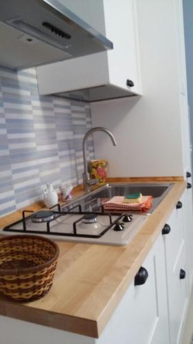 a kitchen with a sink and a stove top oven at Appartamento Castel Sant'Angelo in Licata