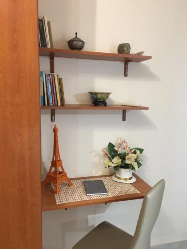 a desk with a chair and a shelf with a tower at Domus Archimede in Siracusa