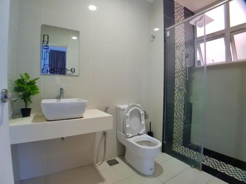 a bathroom with a toilet and a sink and a shower at No.4 The Cave @ Puchong Skypod Residence in Puchong