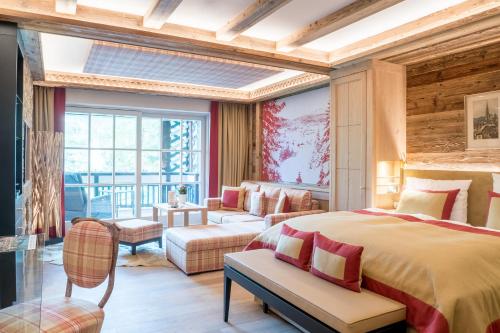 a bedroom with a bed and a living room at Alpin Resort Sacher in Seefeld in Tirol