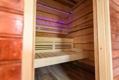 a sauna with a bench inside of it at Luxexcellent super suite in Nuland