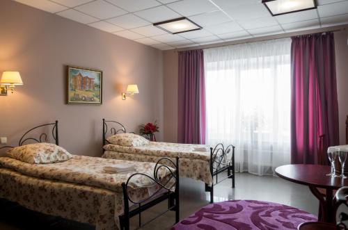 Postel nebo postele na pokoji v ubytování Ermitazh Hotel Complex