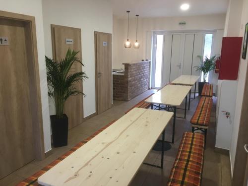a row of tables and stools in a room at Penzion U Hujňáků in Rohatec
