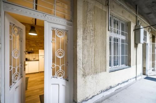 an entrance to a building with doors and windows at BpR Whistle Arts Industrial Apartment in Budapest
