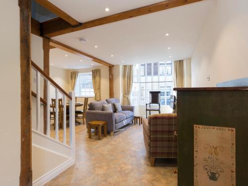 a living room with a couch and a table at Charles I in Winchcombe