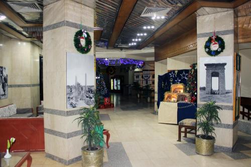 un vestíbulo con coronas de Navidad y adornos navideños en Gaddis Hotel, Suites and Apartments, en Luxor