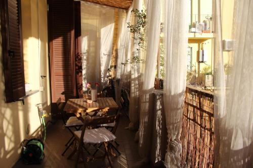 a balcony with a table and chairs on a balcony at Lovely Terrace Apartment in Milan