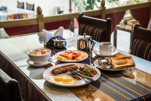 a table with breakfast foods and coffee on it at Hotel Yambu kathmandu in Kathmandu