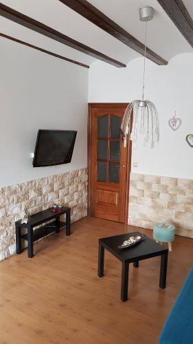 a living room with two tables and a flat screen tv at Apartment Denia 66 in Valencia