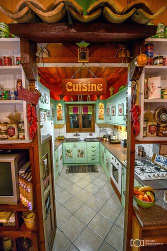 a kitchen with green cabinets and a counter top at Traditional Guesthouse in Tríkala