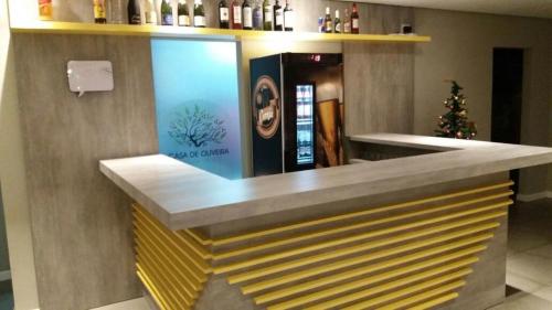 a bar in a restaurant with a christmas tree at Casa de Oliveira Hostel in Torres