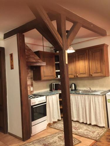 a kitchen with wooden cabinets and a stove top oven at Apartmán Verona in Český Krumlov