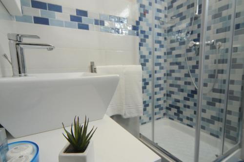 a bathroom with a glass shower and a sink at La Casa di Giorgio Panoramic Rooms in Naples
