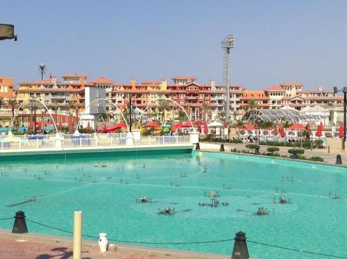 a large swimming pool with people in the water at Chalets in Porto Sharm - Families Only AN in Sharm El Sheikh
