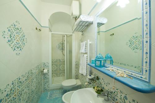 
a bathroom with a toilet, sink, and shower at Hotel La Conchiglia in Praiano

