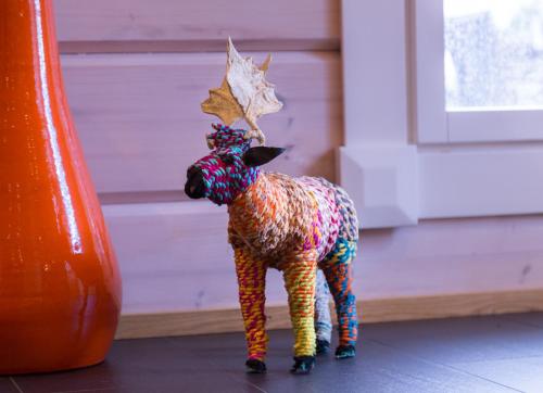 a colorful toy lamb standing next to a door at Villa Älgen in Bamböle