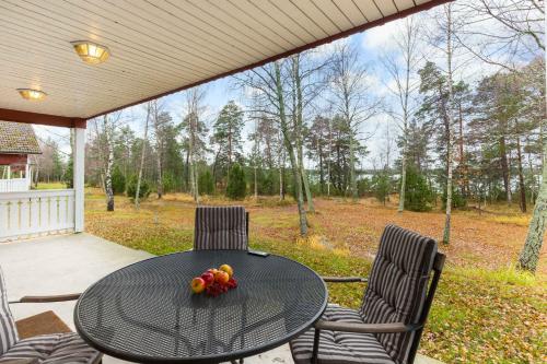 a table and chairs on a porch with fruit on it at Norrö Holiday Village in Bamböle