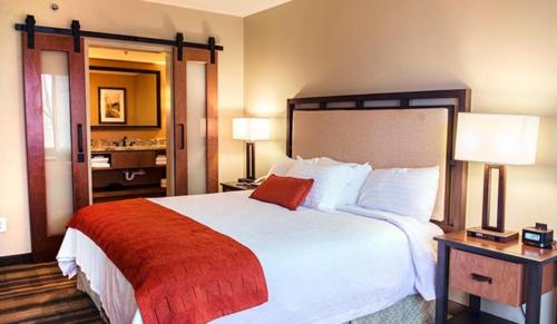 a hotel room with a large bed and a bathroom at Amicalola Falls State Park and Lodge in Dawsonville