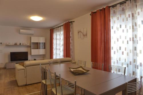 a living room with a table and a couch at Villa Artemia in Manerba del Garda